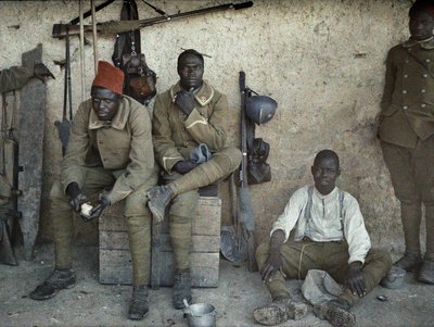 Senegalese soldiers serving in the French Army as infantrymen resting in a room with guns and equipment, Saint-Ulrich, Department Haut-Rhin, Alsace, France, June 16, 1917 by Paul Castelnau